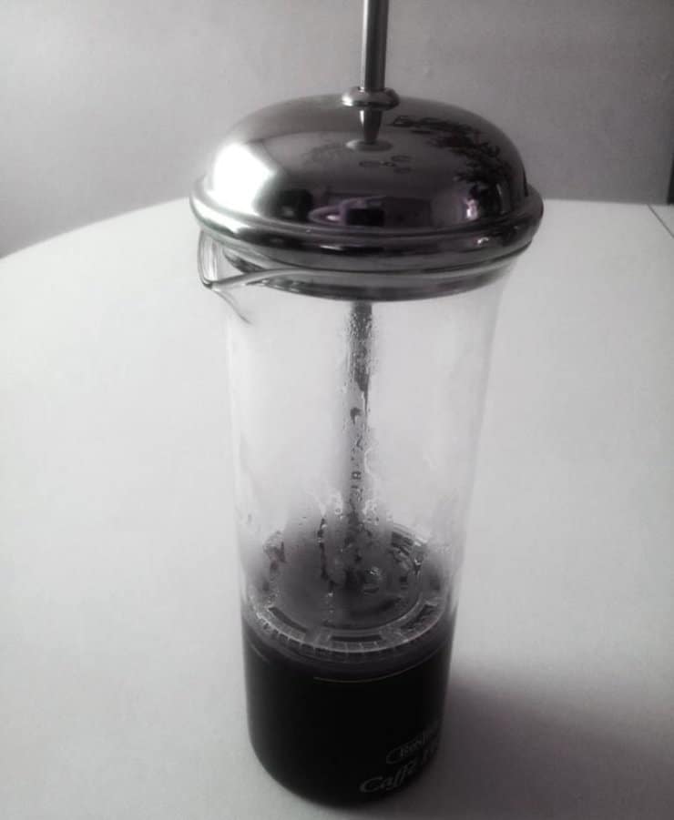 glass press pot with brewed coffee